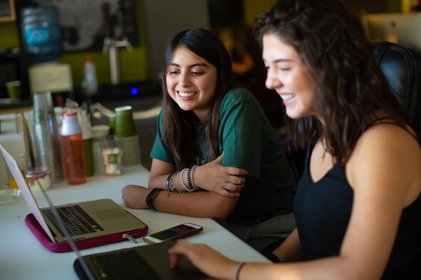 Two founding students of Jungle Disk sitting at the computers 