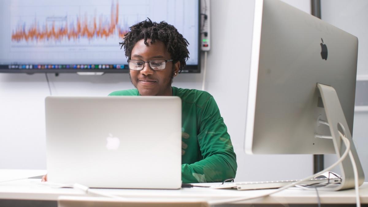 student sitting in front of a computer