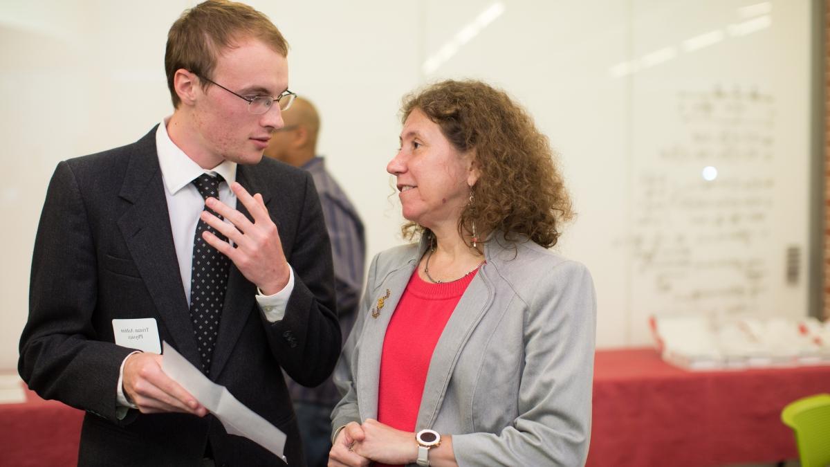 Gabriela Gonzalez speaks with a student before a lecture in CSI